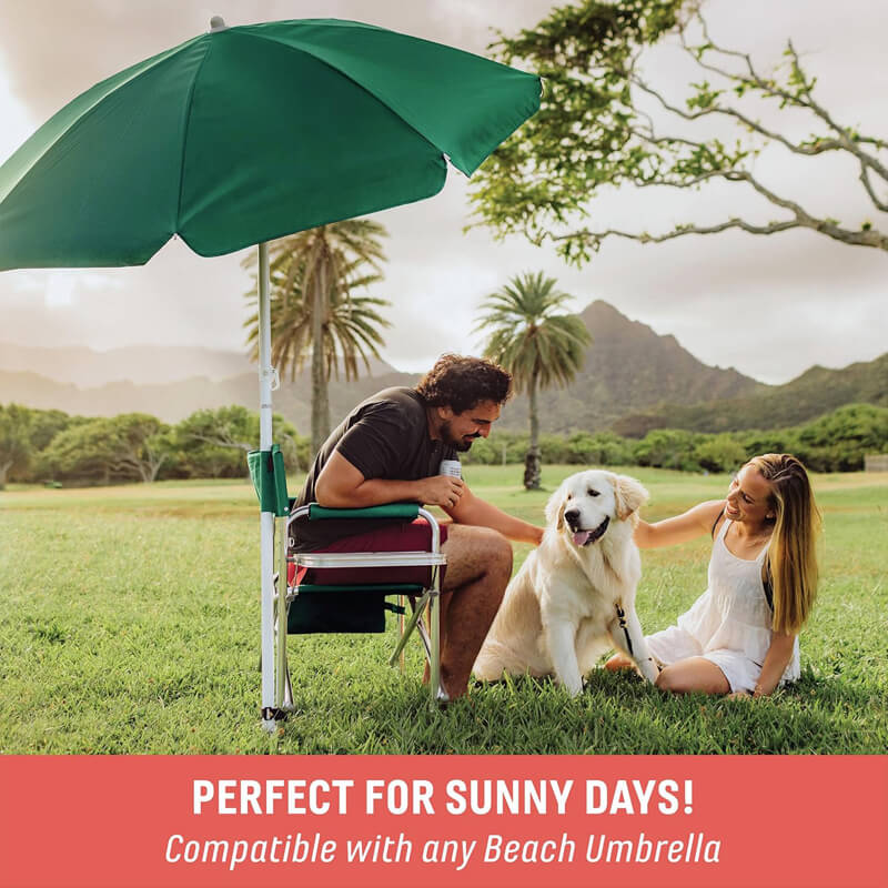 Outdoor folding chair with green sun umbrella; grass scene display; a couple interacting with a golden retriever.